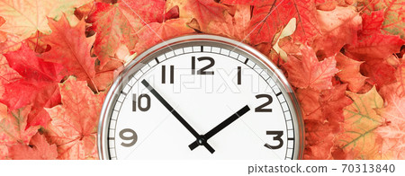 Plain wall clock in the center on red fall foliage Plain wall clock in the center on red fall foliage 70313840