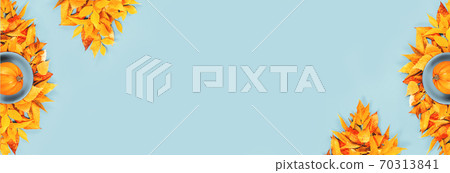 One pumpkin on blue plate and autumn leaves flat lay banner One pumpkin on blue plate and autumn leaves flat lay banner 70313841