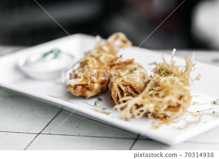 asian fried rice noodle shrimp spring rolls starter on plate 70314938