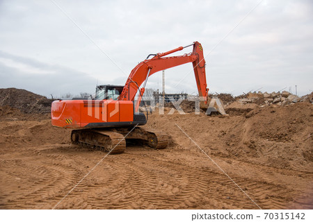 Track-type excavator during earthmoving at construction site.  70315142
