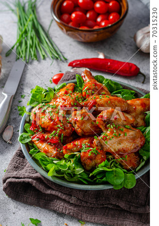 Delicious hot wings with chilli and garlic 70315230