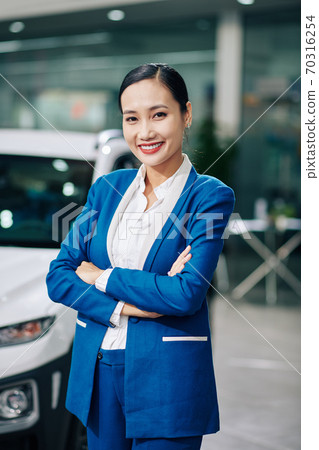 Confident car dealership manager 70316254