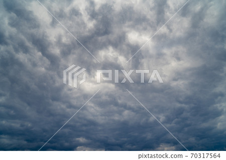 dark grey cloudy sky with epic clouds above city. dark grey cloudy sky with epic clouds above city. 70317564