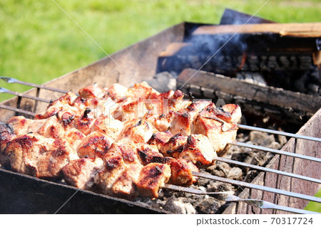 Meat skewers on skewers are grilled in the open air 70317724