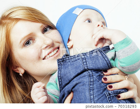 young beauty mother with cute baby toddler, red head happy modern family, lifestyle people concept 70318293