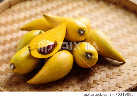 Eggfruit or canistel on bamboo tray, Thai fruit Eggfruit or canistel on bamboo tray, Thai fruit 70319095