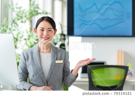 A young business woman working by the window in a bright office 70319181