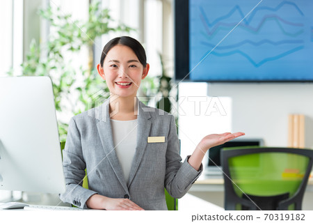 A young business woman working by the window in a bright office 70319182