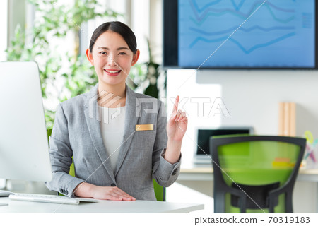 A young business woman working by the window in a bright office 70319183
