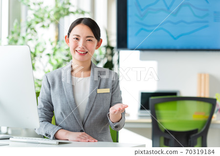 A young business woman working by the window in a bright office 70319184
