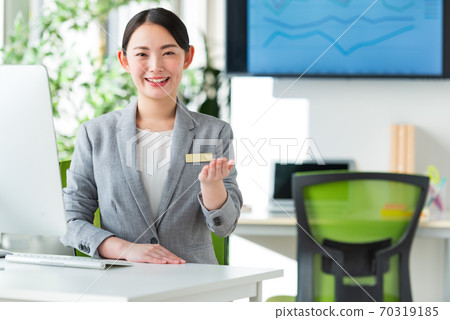 A young business woman working by the window in a bright office 70319185