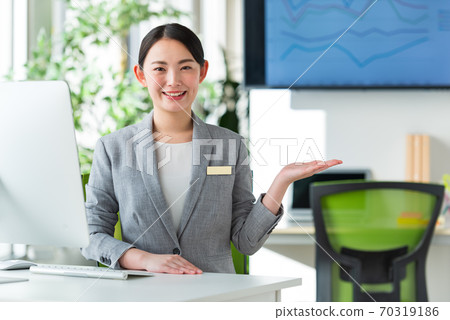 A young business woman working by the window in a bright office 70319186