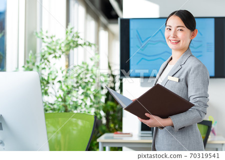 Business woman working in a bright office 70319541