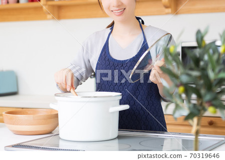 站在廚房裡的年輕女子 70319646