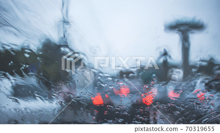 driving car on road in the rain with raindrop over the wind shield, traffic jam in rainy season 70319655
