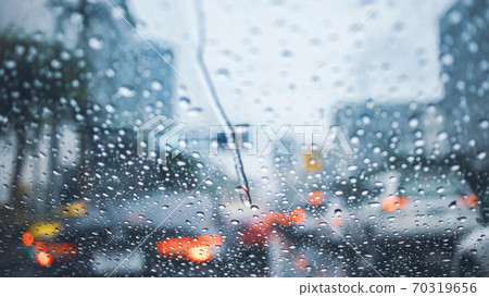 driving car on road in the rain with raindrop over the wind shield, traffic jam in rainy season 70319656