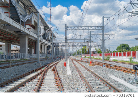 Train or tram on railway with utility poles tower and cable wires in terminal station in urban city in public transportation, energy electric technology and industry concept. Train or tram on railway with utility poles tower and cable wires in terminal station in urban city in public transportation, energy electric technology and industry concept. 70319701