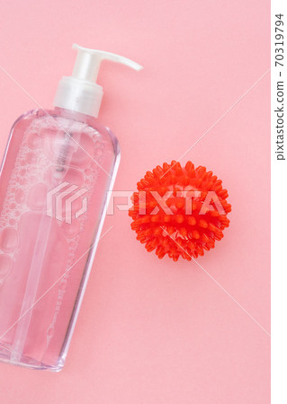 on pink bottle of antiseptic and model COVID-19 on pink bottle of antiseptic and model COVID-19 70319794
