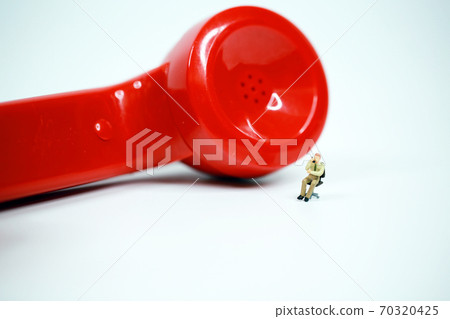 red earphone on call with the office boy 70320425