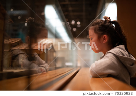 Girl visiting the museum Girl visiting the museum 70320928