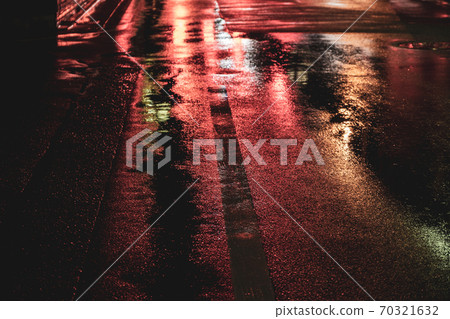 [Transportation] A state of the road in the city on a rainy day that reflects red neon weather 70321632