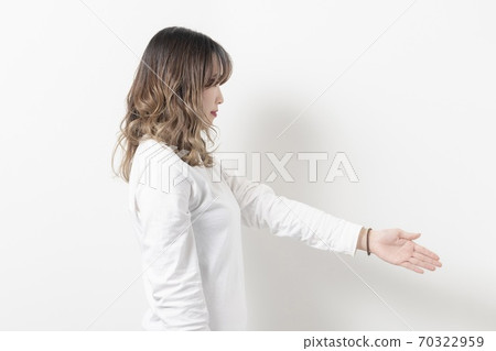 Young woman holding out hand with handshake Young woman holding out hand with handshake 70322959