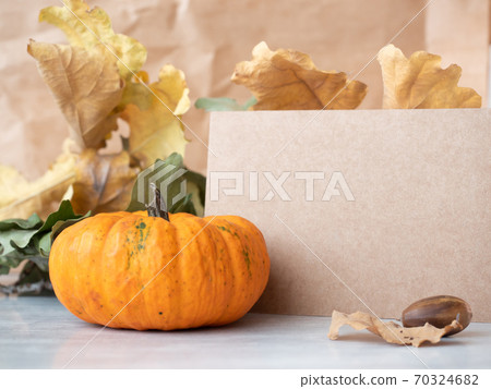 Retro style paper standing near decorative pumpkin 70324682