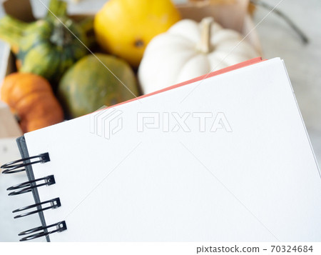 Open empty notebook with autumn leaves and pumpkins around 70324684