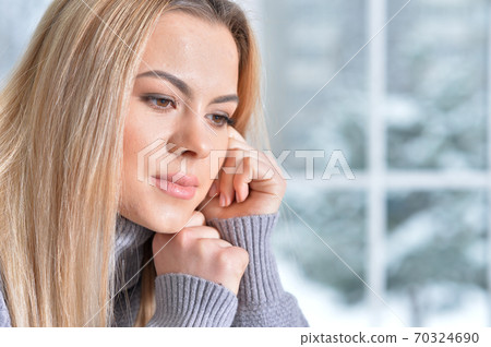 Portrait of beautiful young woman posing at home 70324690