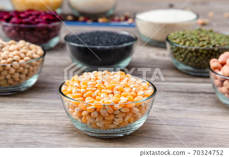 Corn in blow on a wood table background. corn seeds in blow Corn in blow on a wood table background. corn seeds in blow 70324752
