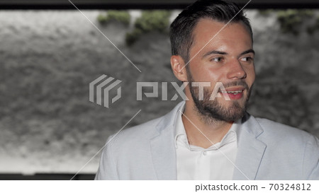 Attractive bearded man enjoying glass of red wine at the bar Attractive bearded man enjoying glass of red wine at the bar 70324812