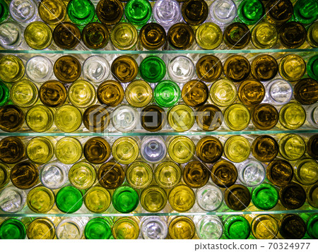 A shelf with glass shelves and stacked bottles A shelf with glass shelves and stacked bottles 70324977