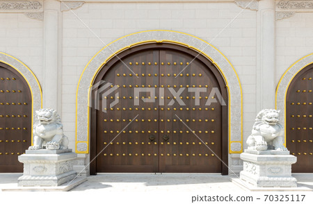 The door and knockers of Chinese temple. Ancient Asian door from temple. Chinese door.  70325117