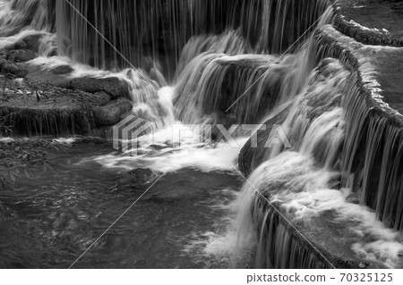 Huay Maekamin Waterfall in Kanchanaburi, Thailand by black and white monochrome photo Huay Maekamin Waterfall in Kanchanaburi, Thailand by black and white monochrome photo 70325125