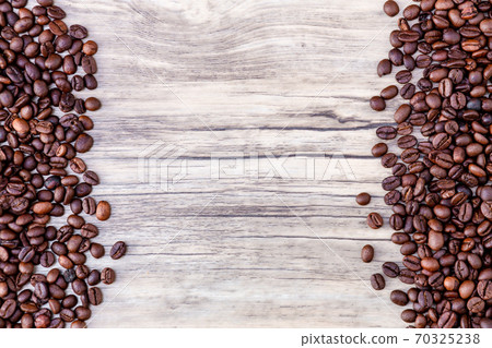 Coffee beans on wooden background. Pile of coffee.  70325238