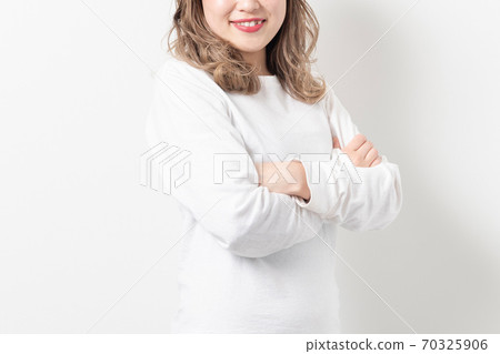 Young woman with arms folded Young woman with arms folded 70325906