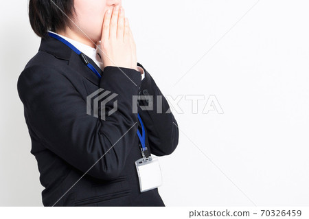 Young business woman who hides her mouth 70326459