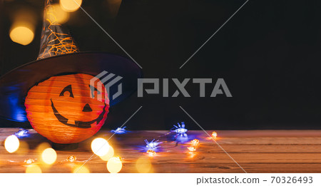 Original decorations with pumpkins and halloween witch hats on rustic wooden background. Original decorations with pumpkins and halloween witch hats on rustic wooden background. 70326493