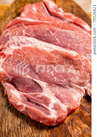 a raw meat, pig neck on a wooden background 70326821