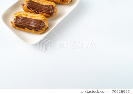 part cakes chocolate icing on white background 70326965