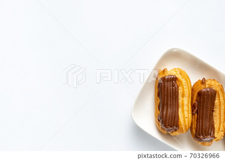 part cakes chocolate icing on white background 70326966