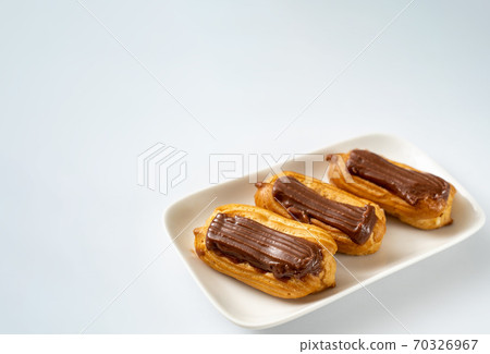 fragment cakes chocolate icing on white background fragment cakes chocolate icing on white background 70326967