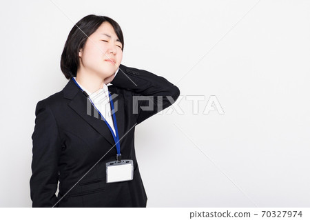 Business woman suffering from stiff shoulders Business woman suffering from stiff shoulders 70327974
