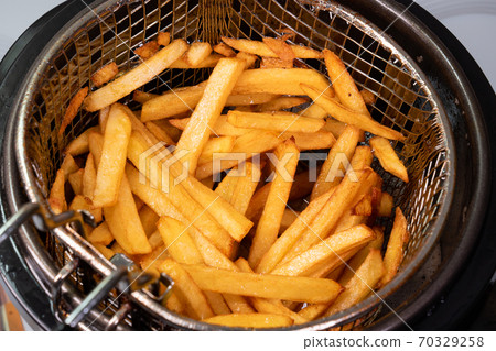 potatoes fries in bowl of grill from fryer closeup potatoes fries in bowl of grill from fryer closeup 70329258
