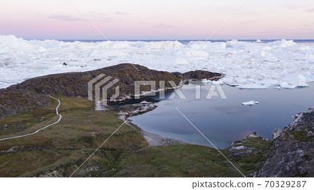 Arctic landscape nature with icebergs and ice in Greenland icefjord. Aerial drone image of ice and iceberg. Ilulissat Icefjord with icebergs from Jakobshavn Glacier aka Sermeq Kujalleq glacier 70329287