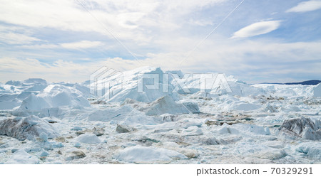 Global Warming and Climate Change - Icebergs from melting glacier on Greenland Global Warming and Climate Change - Icebergs from melting glacier on Greenland 70329291