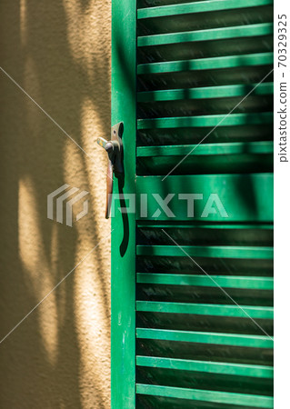 Green armor door where sunlight falls Green armor door where sunlight falls 70329325