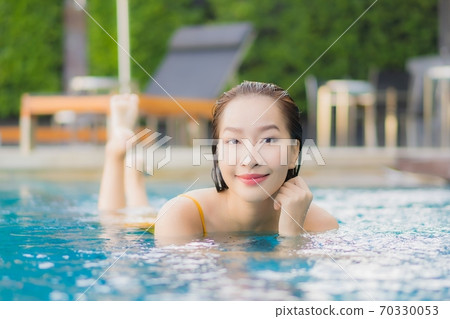 Portrait beautiful young asian woman relax smile leisure around outdoor swimming pool 70330053