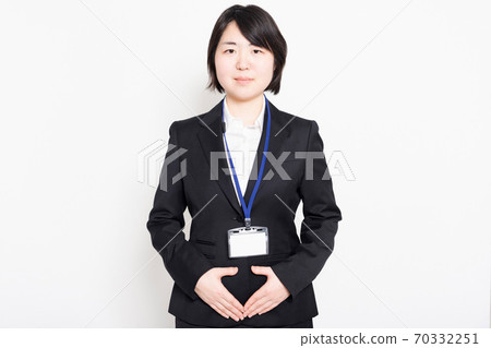 把她的手放在她的肚子上的女商人 把她的手放在她的肚子上的女商人 70332251