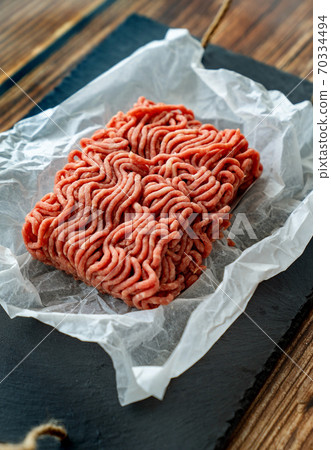 minced meat on cooking paper and stone tray 70334494